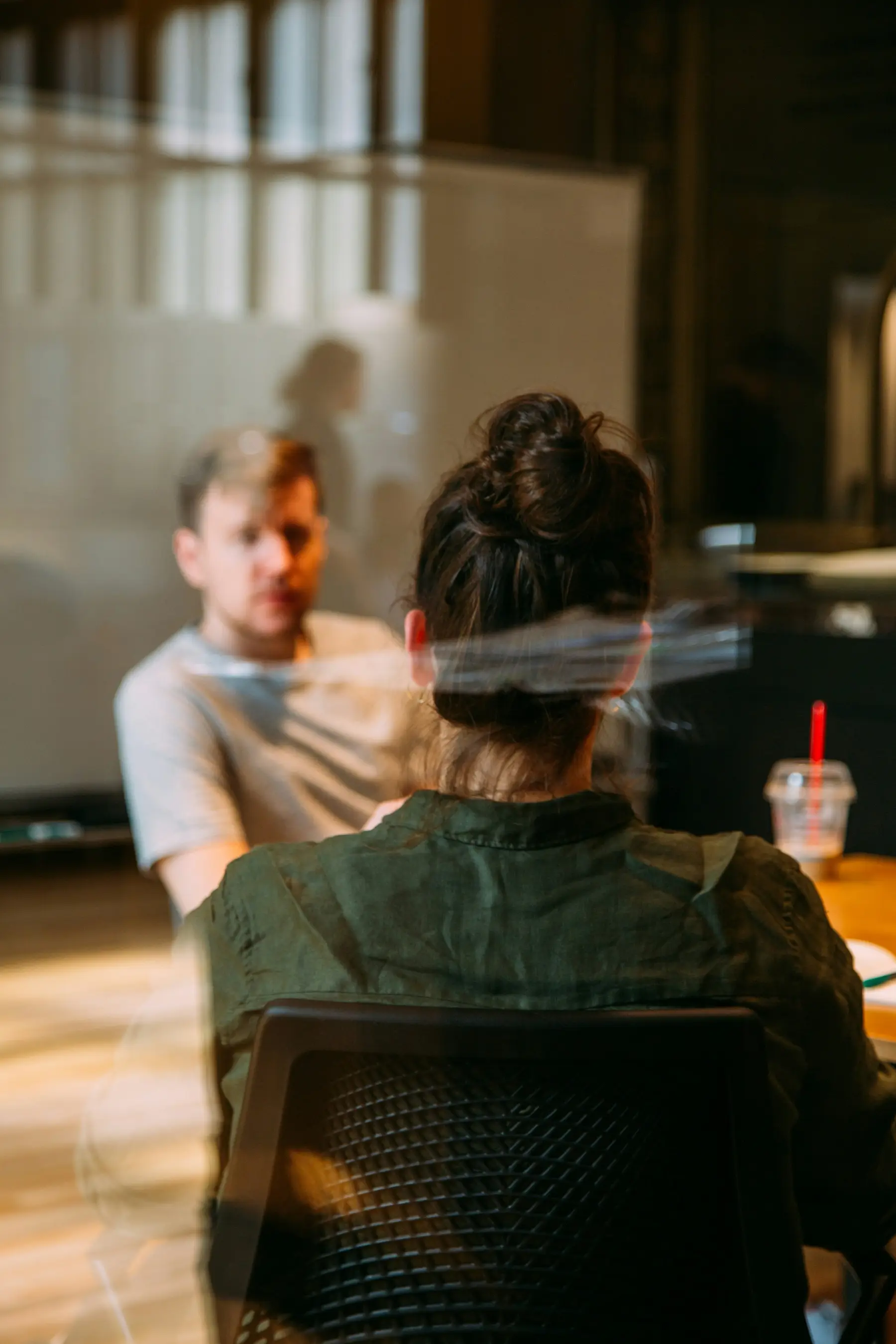 Two people talking across a table